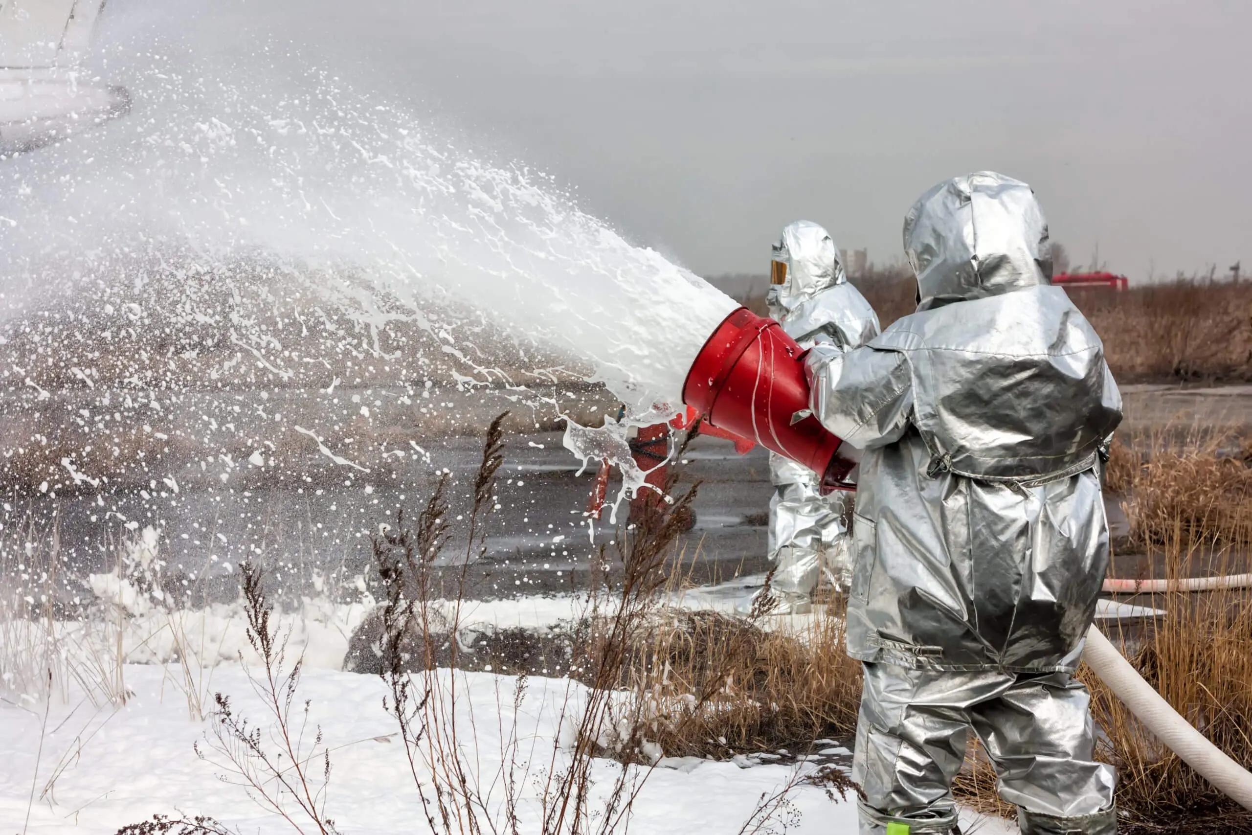 Contamination repellency treatment on firefighter moisture barrier fabric