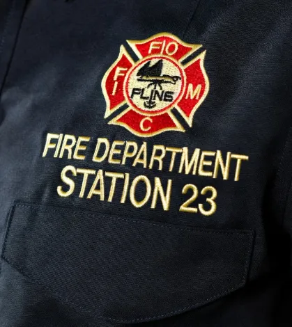 Custom firefighter uniform department branding with embroidered logo and badge placement